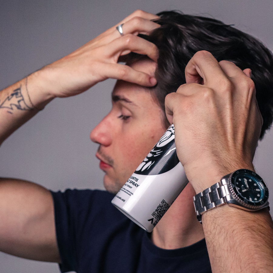 Man using Poseidon Hair Sea Salt Spray to style men’s hair