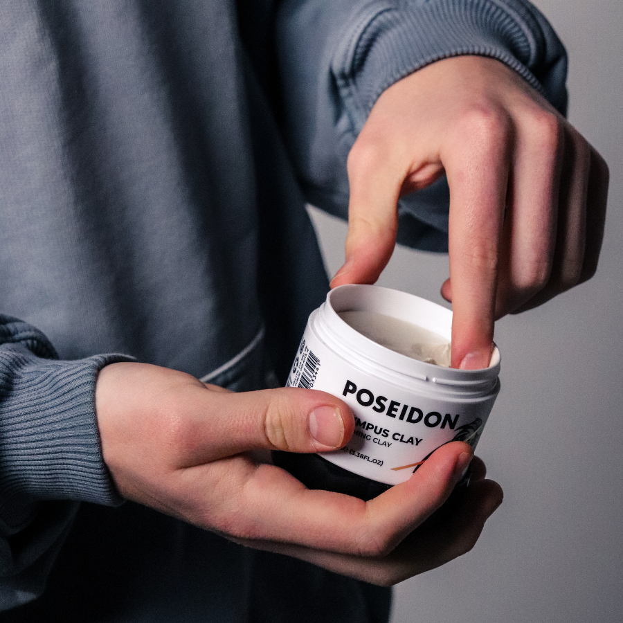 Hand scooping Poseidon Hair Grooming Clay from tub