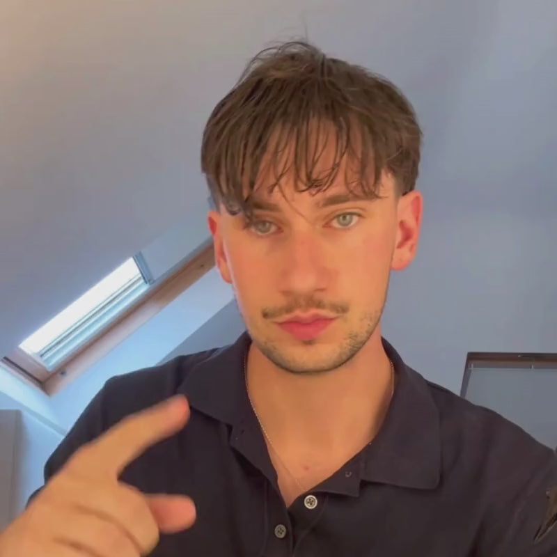 Man styling textured fringe with Poseidon Hair Sea Salt Spray