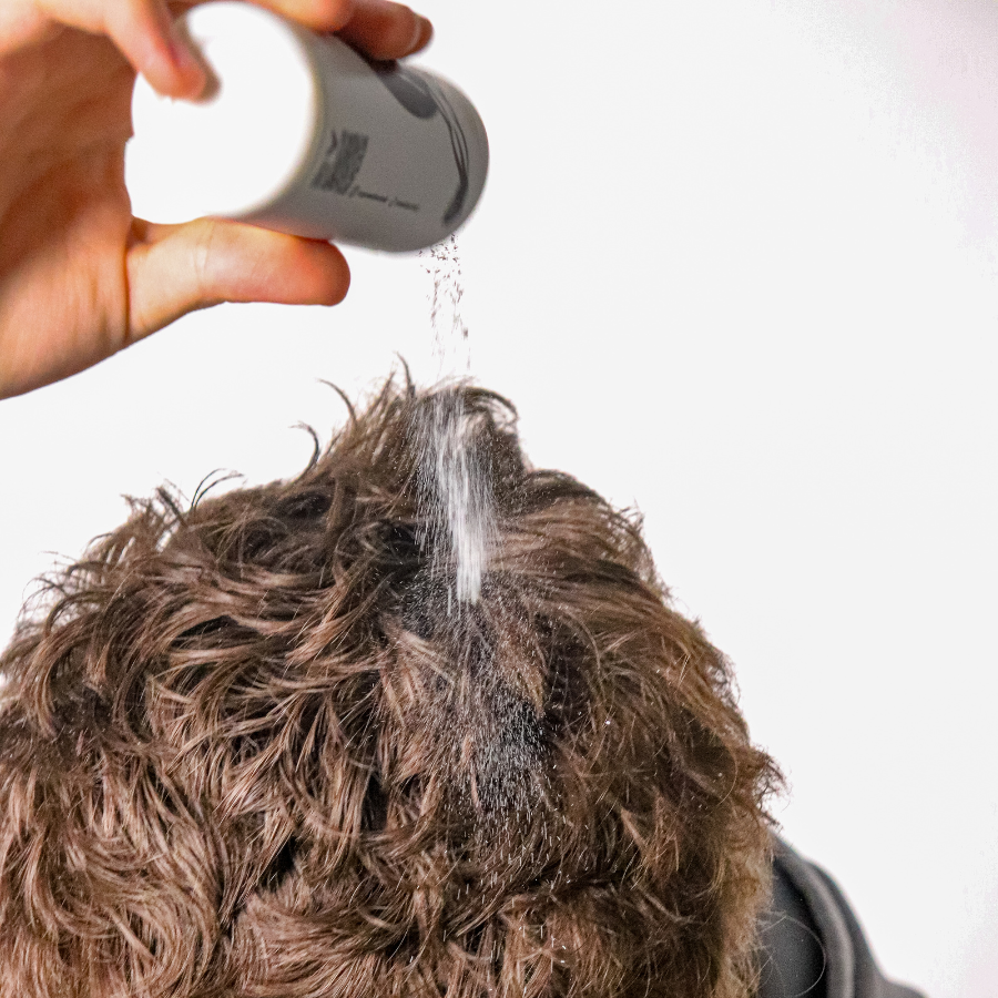 Man styling hair with Poseidon Hair Texture Powder